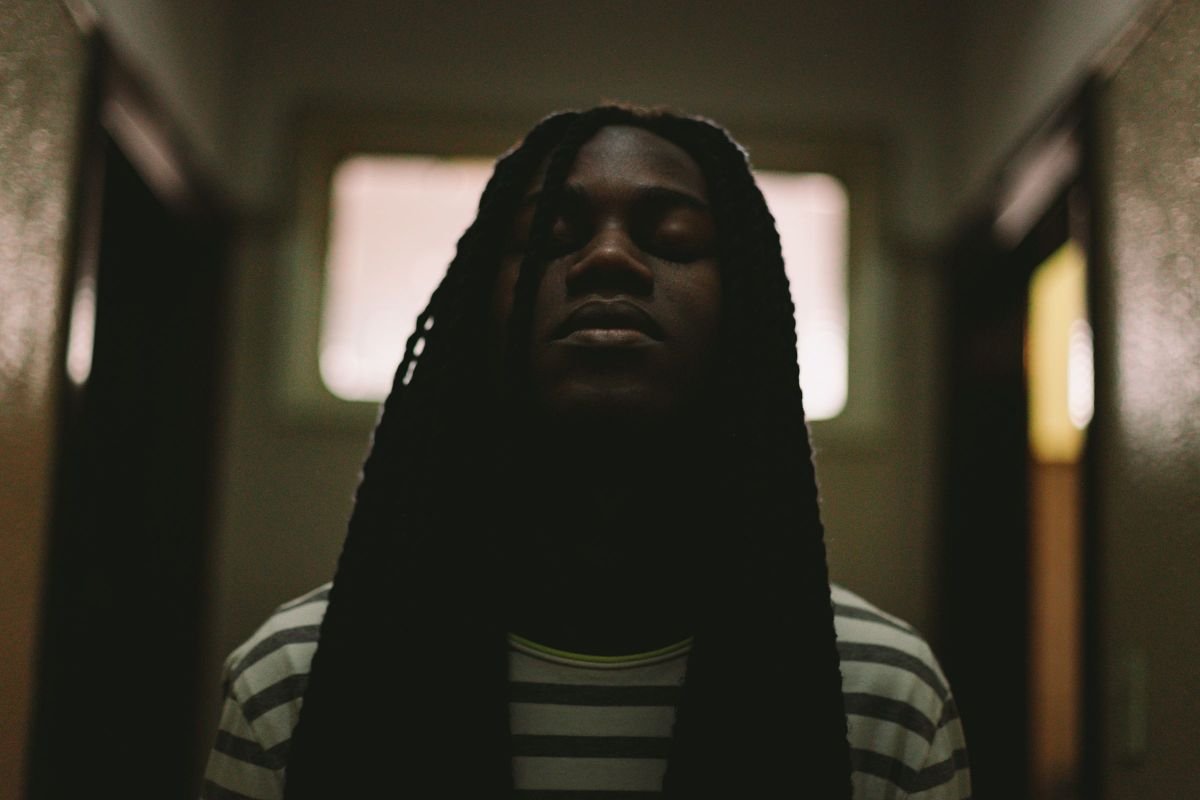 Close-up of a man closing his eyes, grounding himself in the moment