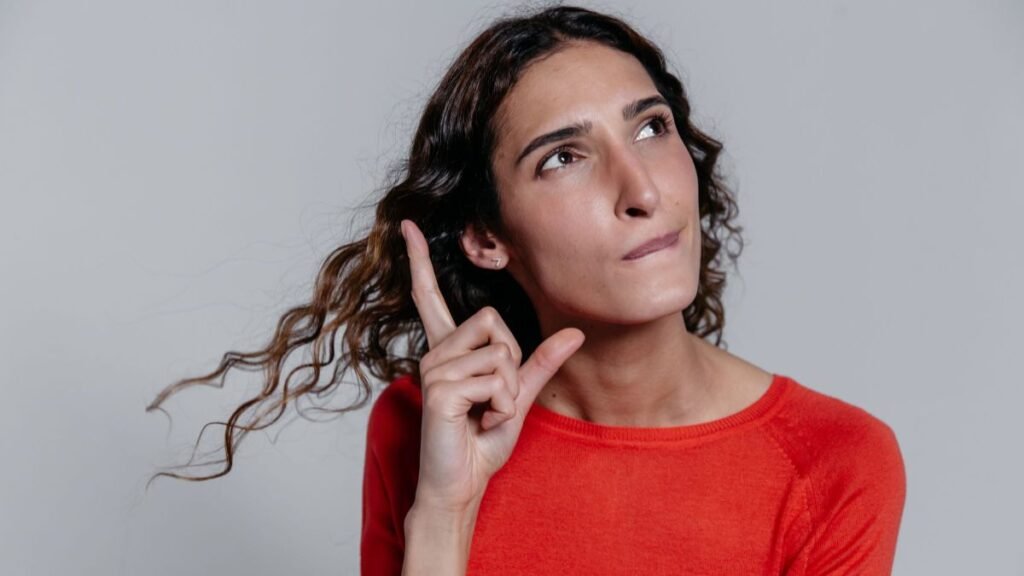 A contemplative woman looking up, thinking deeply