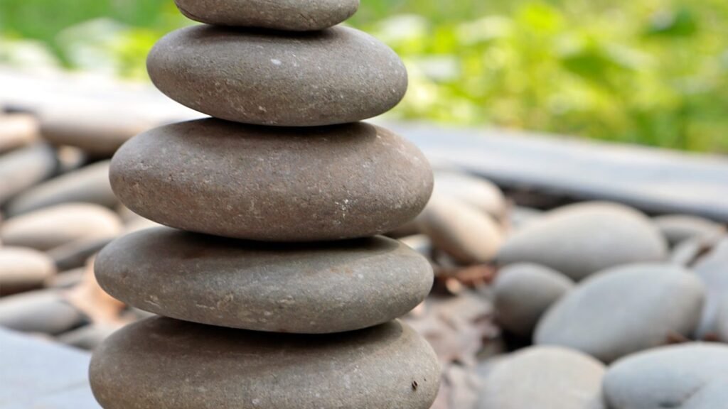 A harmonious pile of carefully balanced stones in a tranquil outdoor setting