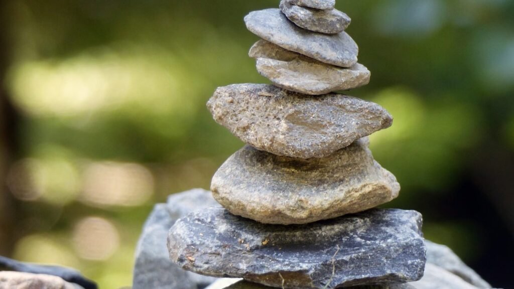 A balanced stone cairn in a natural outdoor setting