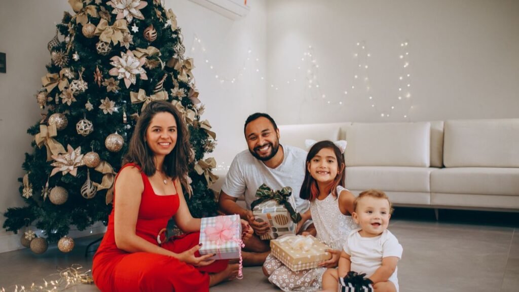 A happy family gathering around a Christmas tree, exchanging gifts