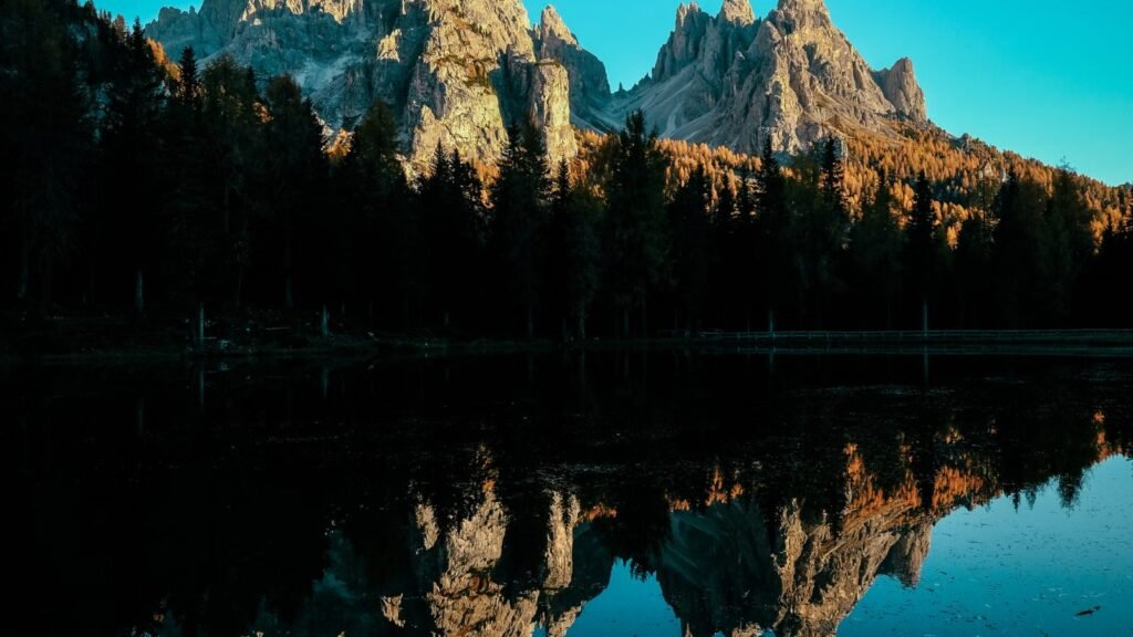 Captivating mountain landscape reflecting in a tranquil lake during sunrise