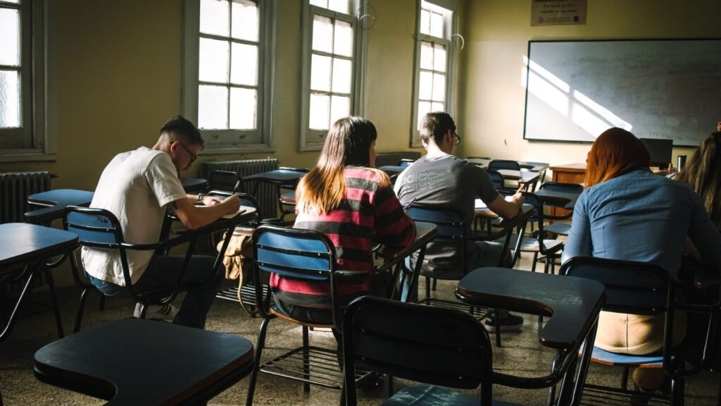Students calmly focused during an exam in a sunlit classroom