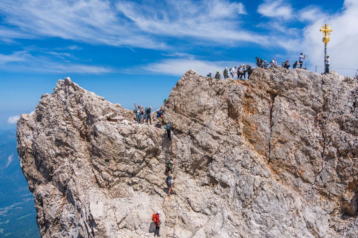 Climbers reaching a mountain summit, symbolising unlocking untapped potential