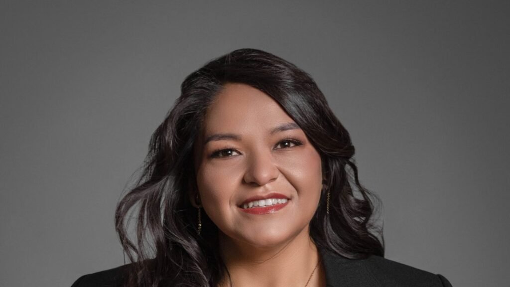 Confident businesswoman in formal attire smiling in a professional portrait