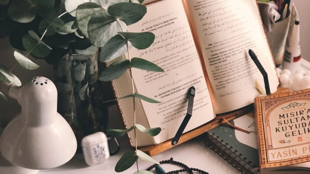 A calm light-filled workspace with books and a tablet