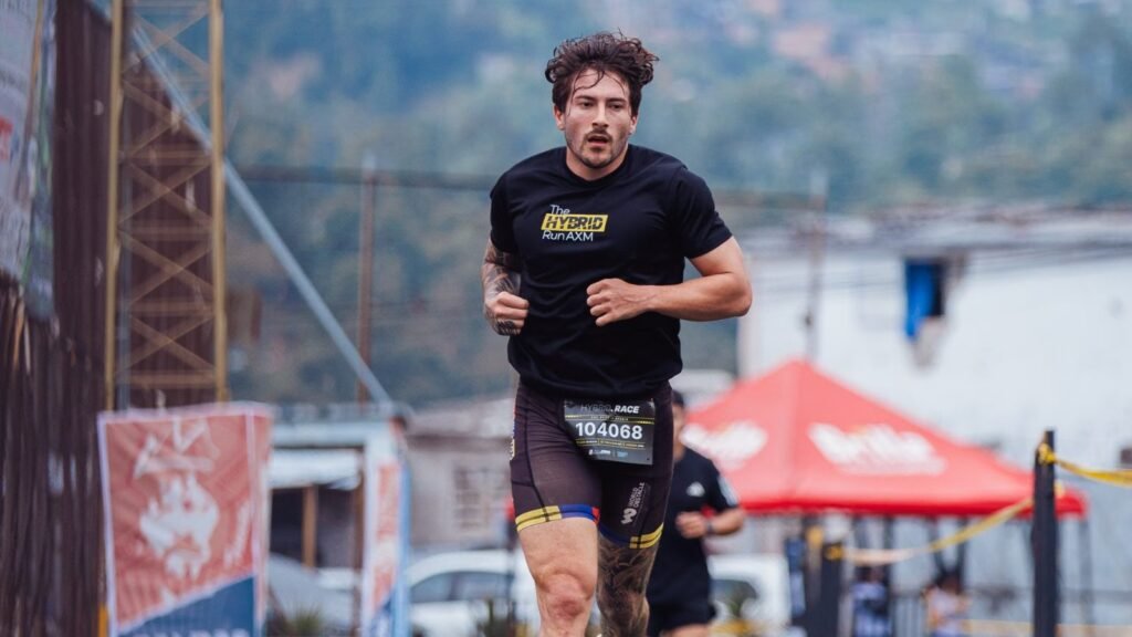 A determined athlete running on an outdoor track during a race
