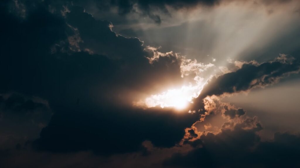 Dramatic sunlight breaking through dark clouds