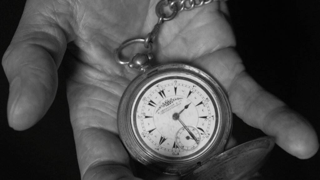 Elegant black and white vintage pocket watch on a chain