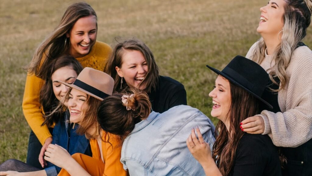 Group of friends laughing and having fun together on a picnic