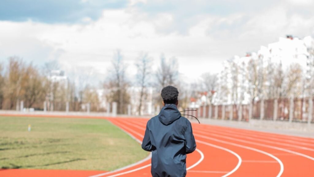 A woman runner exercising on a track outdoors, taking determined action