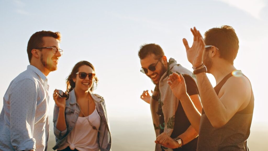 Group of friends laughing and having fun together outdoors