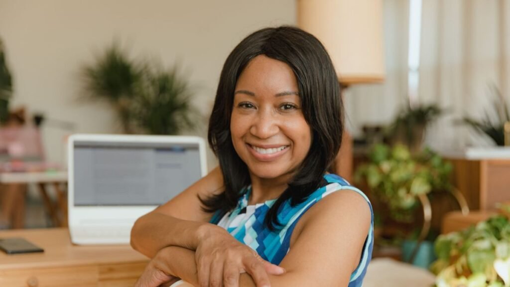 Confident smiling businesswoman sitting at her desk