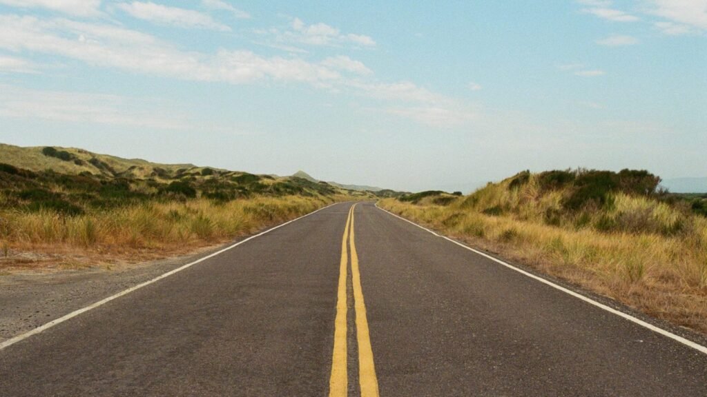 Long open road stretching through scenic countryside