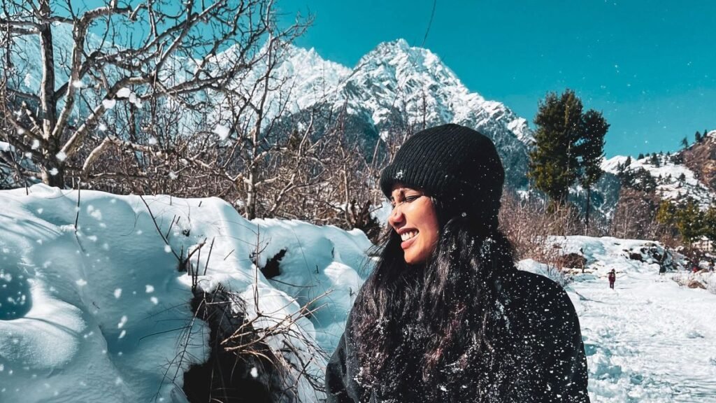 A smiling woman enjoying winter nature in the snow