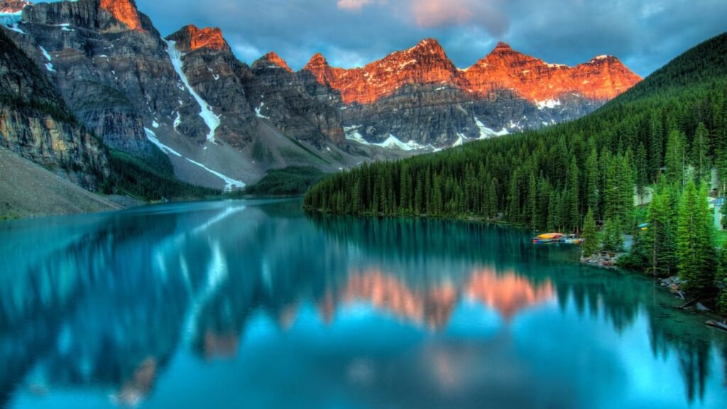 Mountain landscape reflecting in a tranquil lake at sunrise