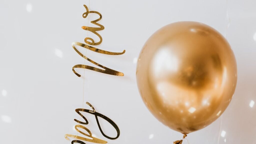 Elegant New Year Eve setup with balloons, champagne and festive lights