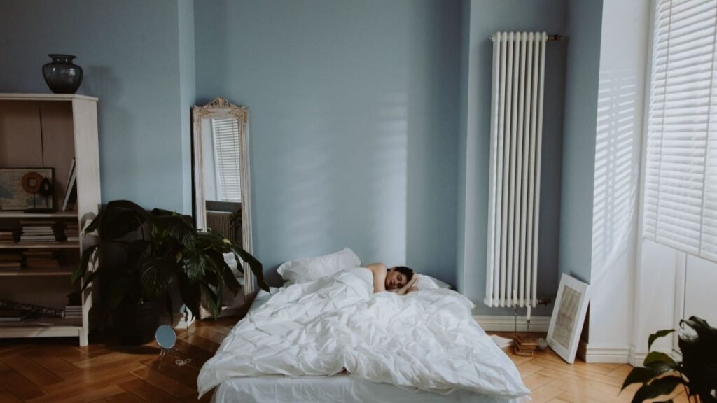 Person sleeping peacefully in a cozy, softly lit bedroom