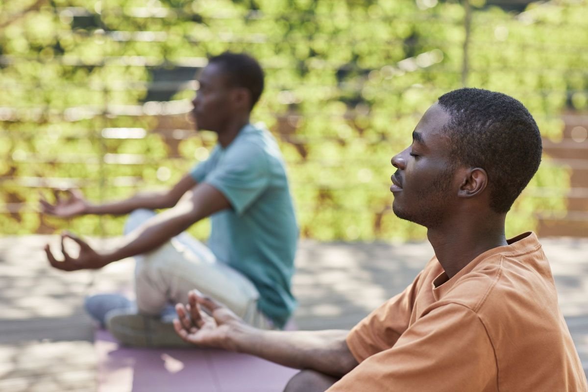 Person meditating calmly outdoors, practicing mindfulness