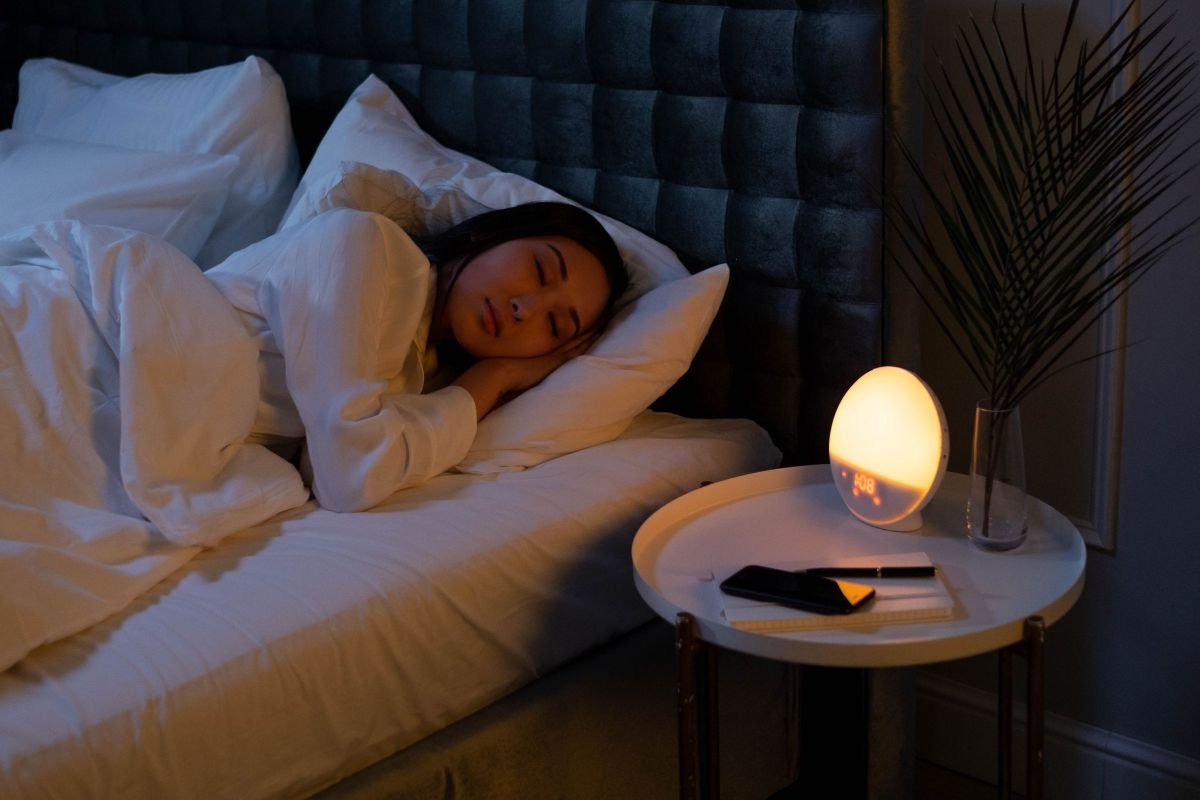 Woman sleeping peacefully in a calm, softly lit bedroom