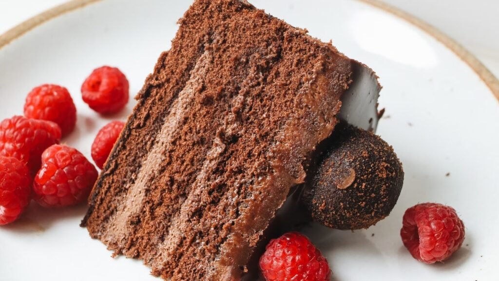 Close-up of a decadent sliced chocolate cake on a ceramic plate
