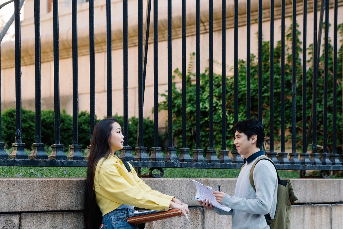 Two friends standing together talking, encouraging one another with support