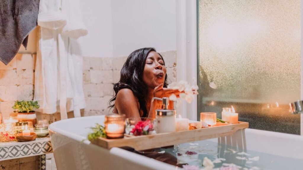 A serene woman enjoying a relaxing spa bath surrounded by candles and flowers