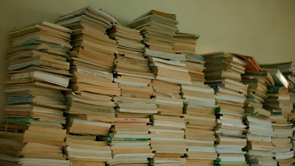 A large collection of stacked vintage books