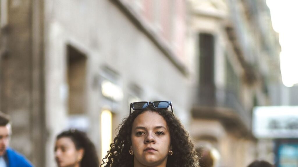 Confident woman walking down a city street, unbothered and self-assured