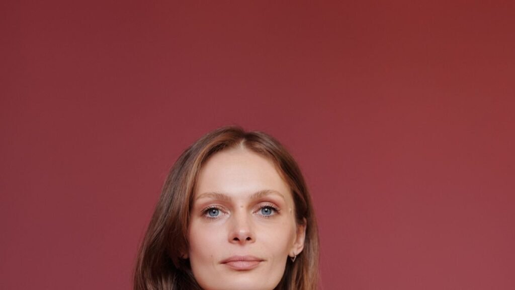 Confident businesswoman standing with arms crossed, looking directly at the camera